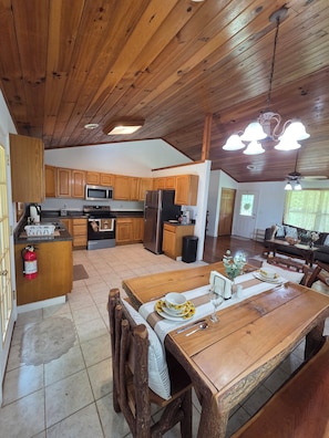 A spacious kitchen with wooden cabinets, a central island, and modern appliances.