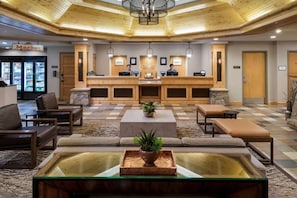 A lobby with a reception desk, seating area, and a check-in counter. - 2 Bedroom Villa Sheraton Lakeside Terrace Resort (Avon)