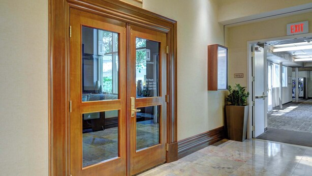 A hotel lobby with double wooden doors, a sign reading "The Lounge," and an exit sign. - MGM Signature-27-705 F1 Track & Strip View Balcony (Las Vegas)