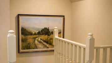 A staircase with white balusters and a carpeted landing.