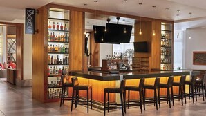A bar area with a long counter, multiple bar stools, and shelves stocked with bottles. - 2 Bedroom Villa Westin Riverfront Mountain Resort (Avon)