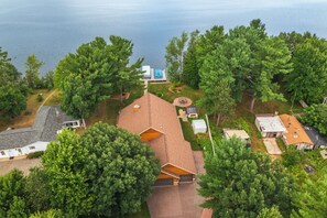 A residential area with multiple houses, a swimming pool, and a well-maintained lawn.