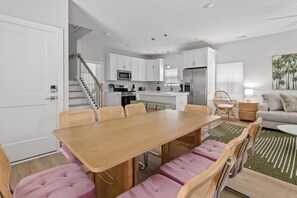 A modern kitchen with white cabinets, a stainless steel refrigerator, and a microwave. - Pink Palmetto 2.5 Blocks to Beach Pets (Myrtle Beach)
