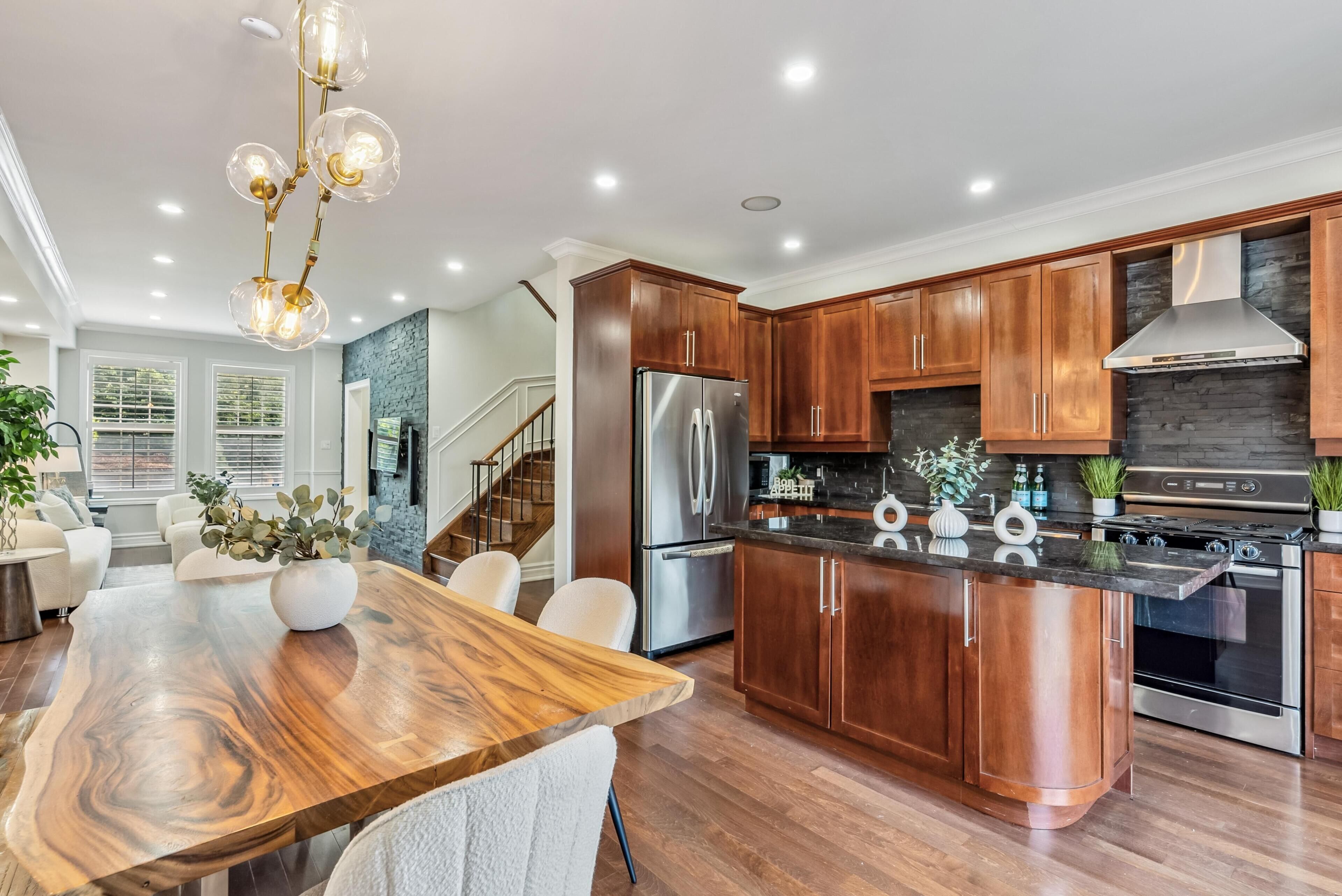 A modern kitchen with wooden cabinets, stainless steel appliances, and a central island.