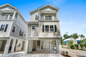 A two-story residential building with a covered front porch and a second-floor balcony. - The Golden Tee - Pet Friendly-2.5 Blocks to Beach (Myrtle Beach)