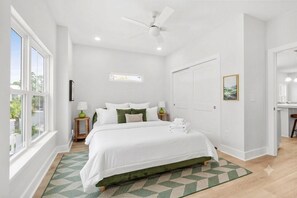 A bedroom with a bed, a ceiling fan, a window, and a door. - The Golden Tee - Pet Friendly-2.5 Blocks to Beach (Myrtle Beach)