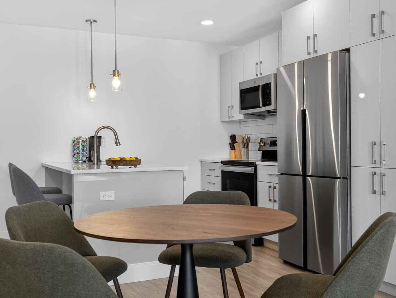 Dining area beside the full kitchen with seating for group meals.