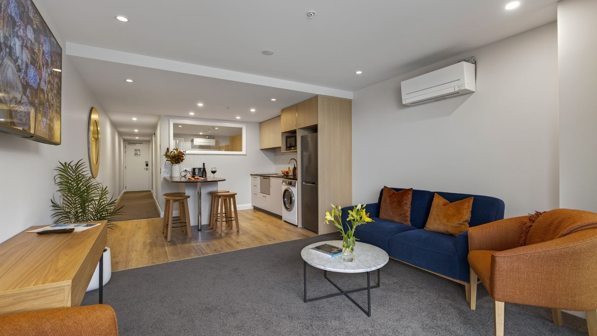 A modern apartment with a living room, kitchen, and dining area.