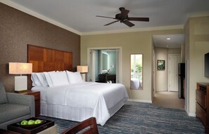 A hotel room with a bed, a desk, a chair, a TV, and a ceiling fan. - ALOHA!! GRAND Ocean view 1-BdRm studio VILLA  on the gorgeous Kaanapail Beach (Lahaina)