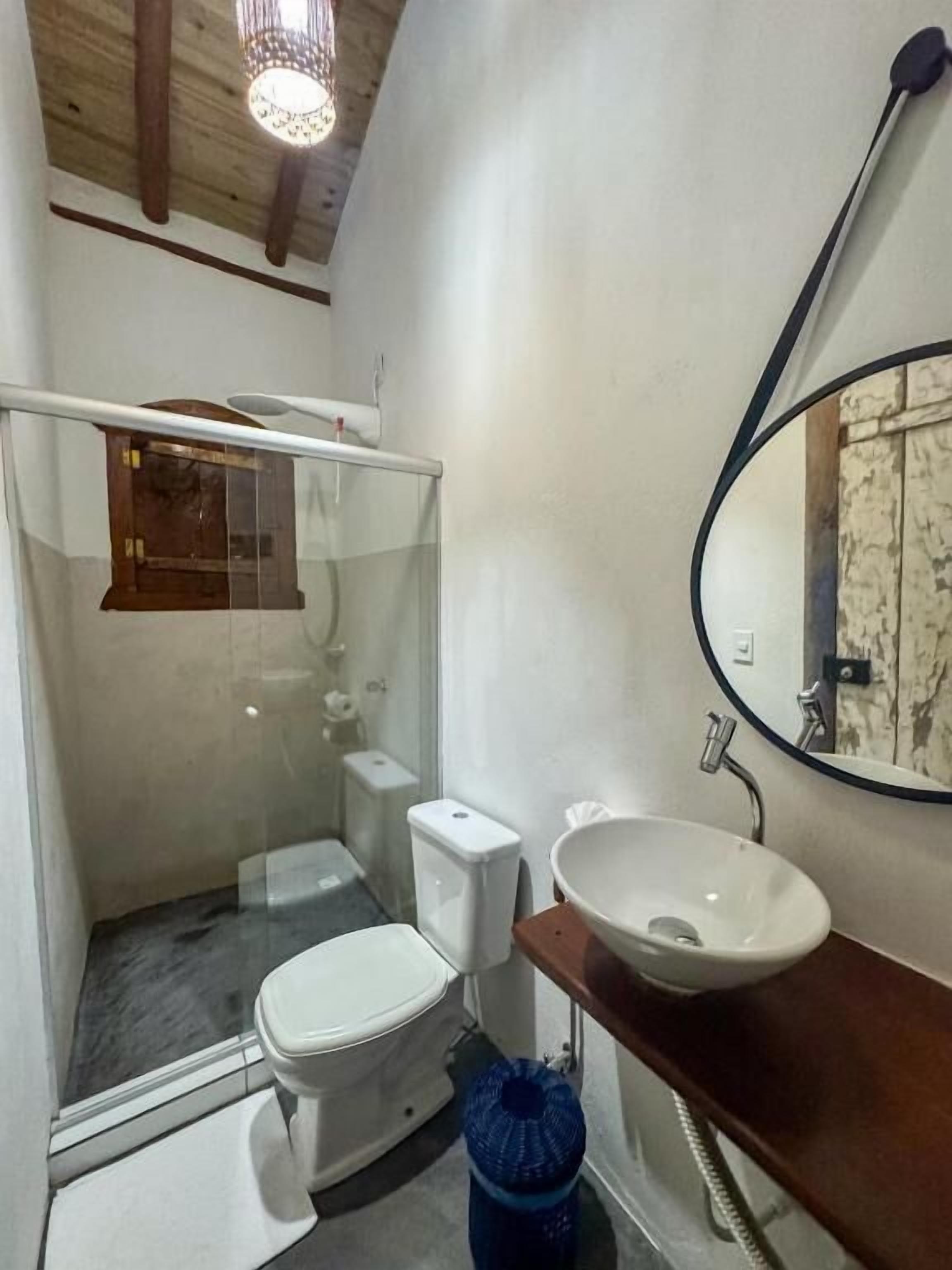 A bathroom with a toilet, a sink, and a shower.