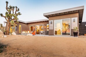 A modern house with a desert garden, large windows, and a fire feature. - Shelter 1 by Homestead Modern (Joshua Tree)