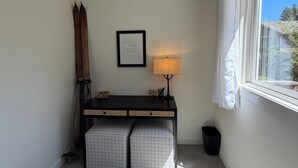A room with a desk, a lamp, a framed quote on the wall, and a window with a view. - Woodside Retreat Estate - Home + Guest Barn (Bend)