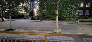 A street view with a sidewalk, trees, and a building with a brick facade. - Cozy Central London, Zone 1 Apartment, Sleeps 5 (London)