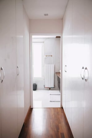 A hallway leading to a bathroom with a white door, a towel rack, and a radiator. - Charming luxury villa near Disneyland Paris. 6 bedrooms. Air-conditioned. Sleeps 16 (Bussy-Saint-Georges)