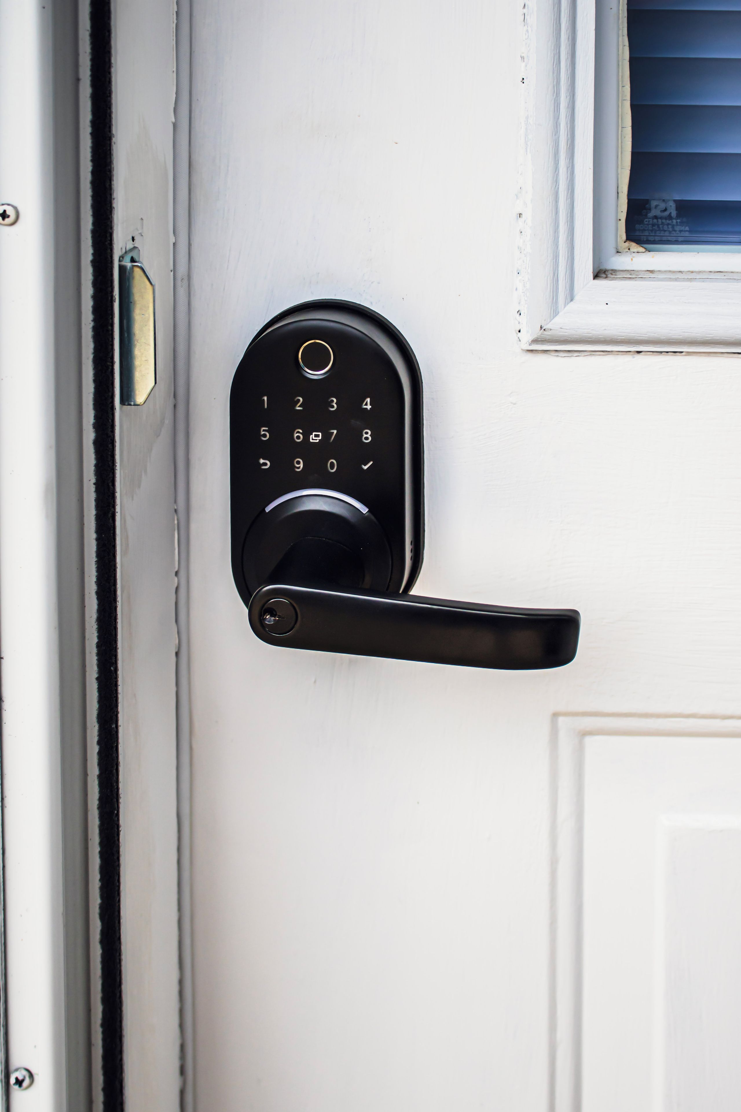 A door with a numeric keypad lock and a lever handle.