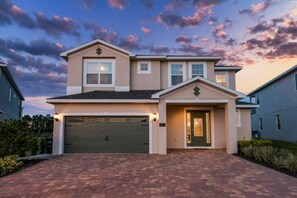 A two-story house with a garage, a front door, and a number '201' on the wall. -  Luxury Disney Escape Private Pool, Spa ,Game Room (Kissimmee)