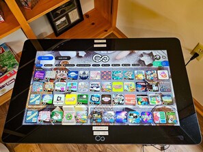 A digital game table with a variety of games displayed on its screen. - Bear Lodge - Hot tub & Bryce Mountain views! (Basye)