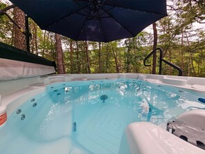 A hot tub surrounded by trees, with an umbrella providing shade. - Bear Lodge - Hot tub & Bryce Mountain views! (Basye)