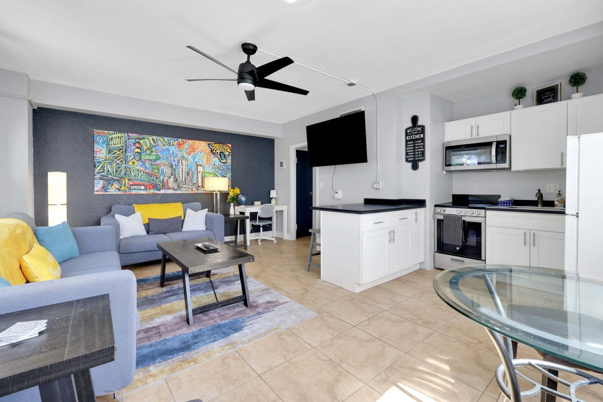 A modern apartment with a living room, kitchen, and dining area.