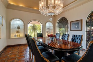 A dining room with a large round table, upholstered chairs, and a chandelier. - Villa Tortuga- Private Lake-View Hacienda Estate in West Ajijic with Pool Cabana (San Antonio Tlayacapan)