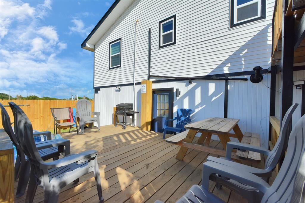 A deck with outdoor furniture and a barbecue grill.