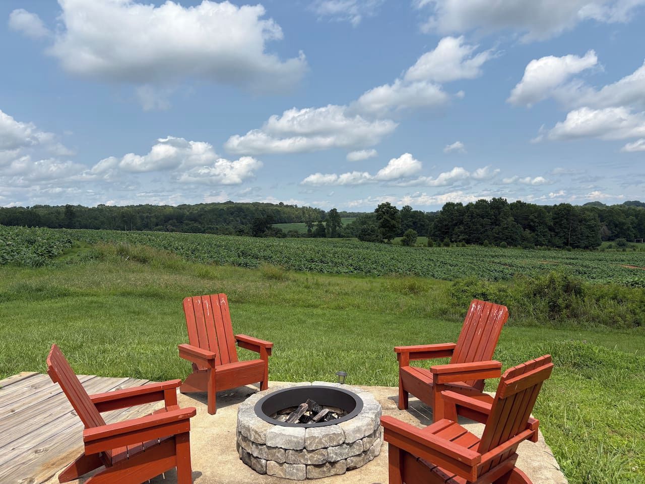 Four Adirondack chairs around the fire pit