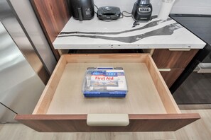 A drawer with a First Aid kit inside. - Château Idaho - Cozy•Sleeps 10•NRG•Med Center•UoH (Houston)