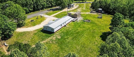 A single-story building with a flat roof, surrounded by a well-maintained lawn and trees.