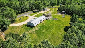 A single-story building with a flat roof, surrounded by a well-maintained lawn and trees. - Your Own Private Storybrook Retreat

Everyone can gather! (Pineville)