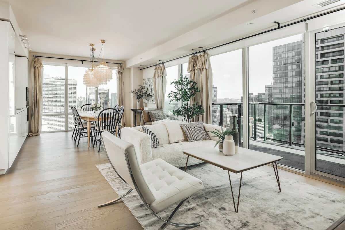 A modern living room with a sofa, coffee table, and dining area.