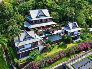 A large, multi-story resort with a swimming pool, lush gardens, and a tropical setting. - Nakawanna Villa (Tambon Kamala)