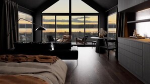 Un dormitorio moderno con un tragaluz grande, un comedor y una cocina.