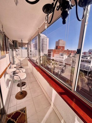 A balcony with a view of a cityscape, including buildings and a clear sky. - 2-bedroom apartment in fabulous Punta del Este with AC and gym (Punta del Este)