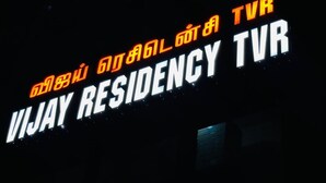 A sign with the text 'VIJAY RESIDENCY TVR' in white and orange letters on a dark background.