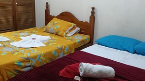 A hotel room with a wooden bed, a red blanket, and a blue pillow. - Room-room Mirador, Casa Del Pueblo (Jardin)