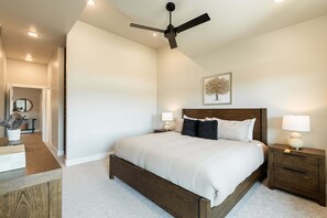 A bedroom with a bed, nightstands, a ceiling fan, a wall-mounted lamp, and a framed picture. - Min to Deer Valley East Newest Terrain, Community Amenities, Free Ski Shuttle (Heber City)
