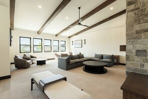 A spacious living room with a sectional sofa, a round coffee table, and a fireplace. - Min to Deer Valley East Newest Terrain, Community Amenities, Free Ski Shuttle (Heber City)