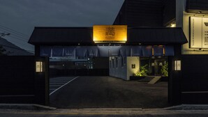 A hotel entrance with a prominent sign and a covered driveway leading to the building. - Mitasuya Ryokan Dongducheon Soyosan (Dongducheon)
