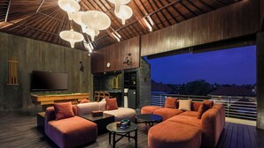 A modern living room with a pool table, comfortable seating, and a large window overlooking a cityscape. - Helene's House (Ubud, Kabupaten Gianyar)