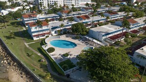 A resort with multiple-story buildings, a central swimming pool, and surrounding greenery. - 3BR Villa Bella Vida in Dorado (Dorado)