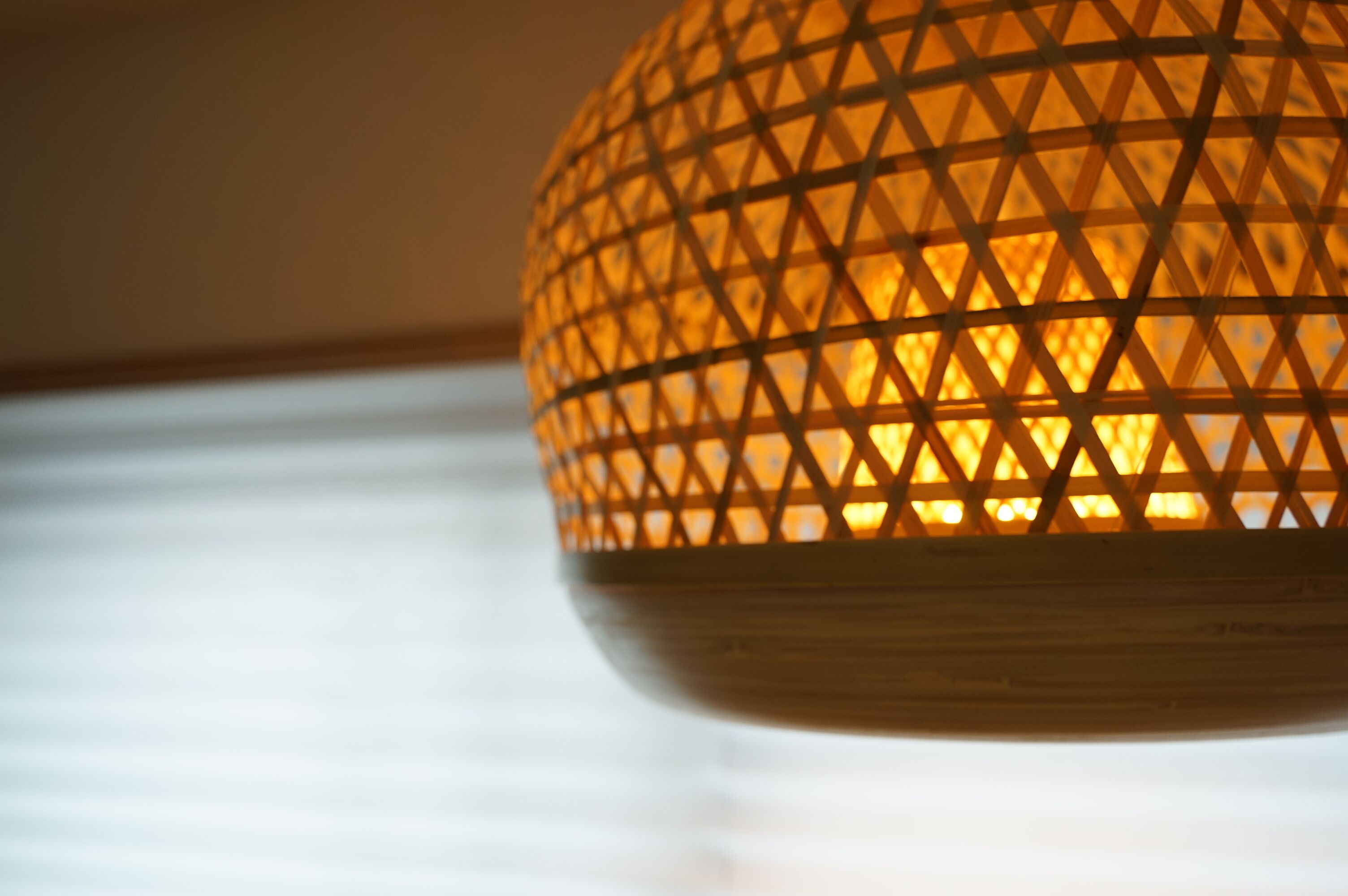 A hanging light fixture with a geometric pattern.