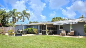 A residential property with a covered patio, outdoor seating, and a barbecue area. - Memories Beach Villa! Near Gulf Beaches + BBQ (Largo)