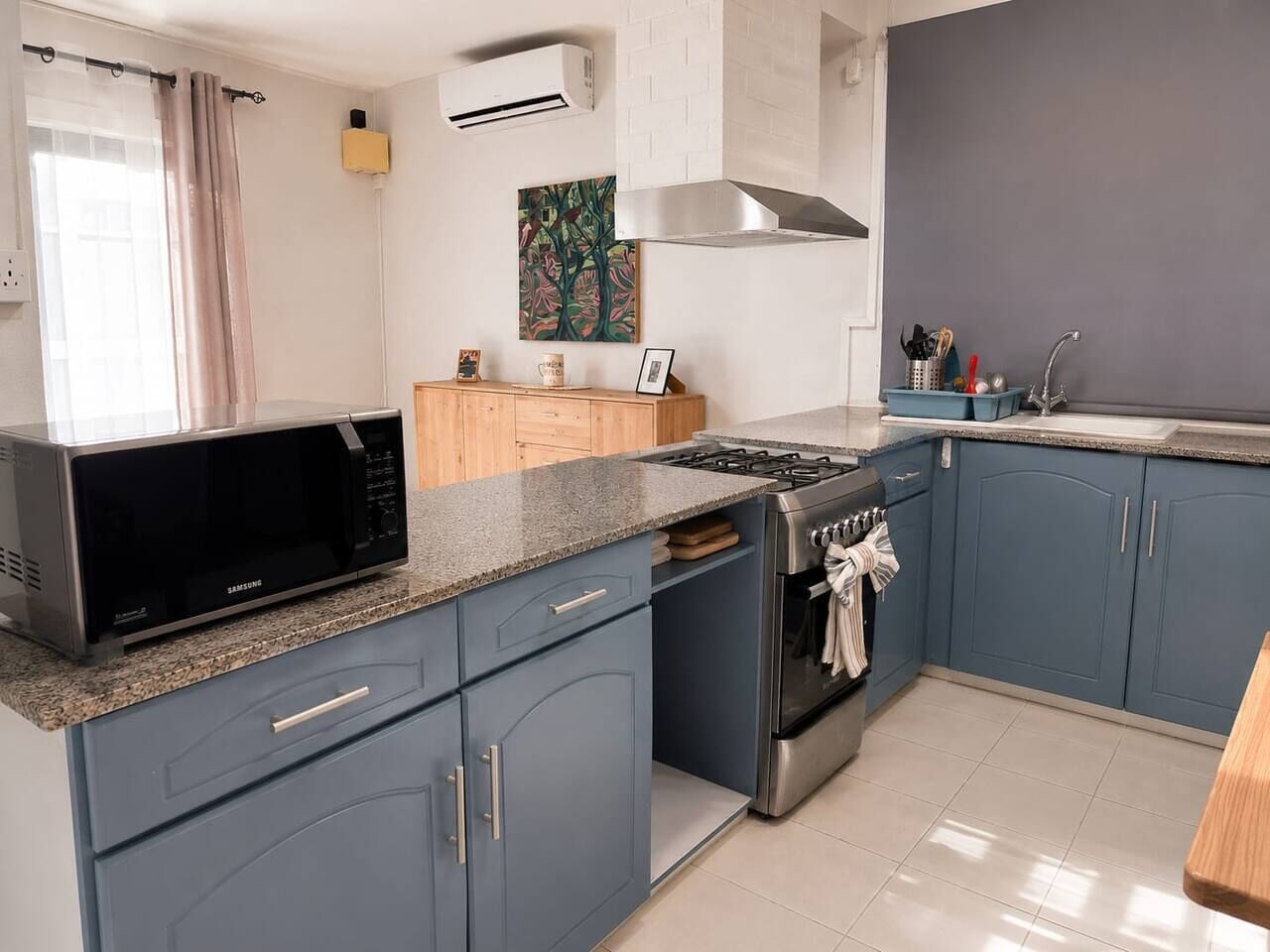 A modern kitchen with a microwave, stove, and sink.