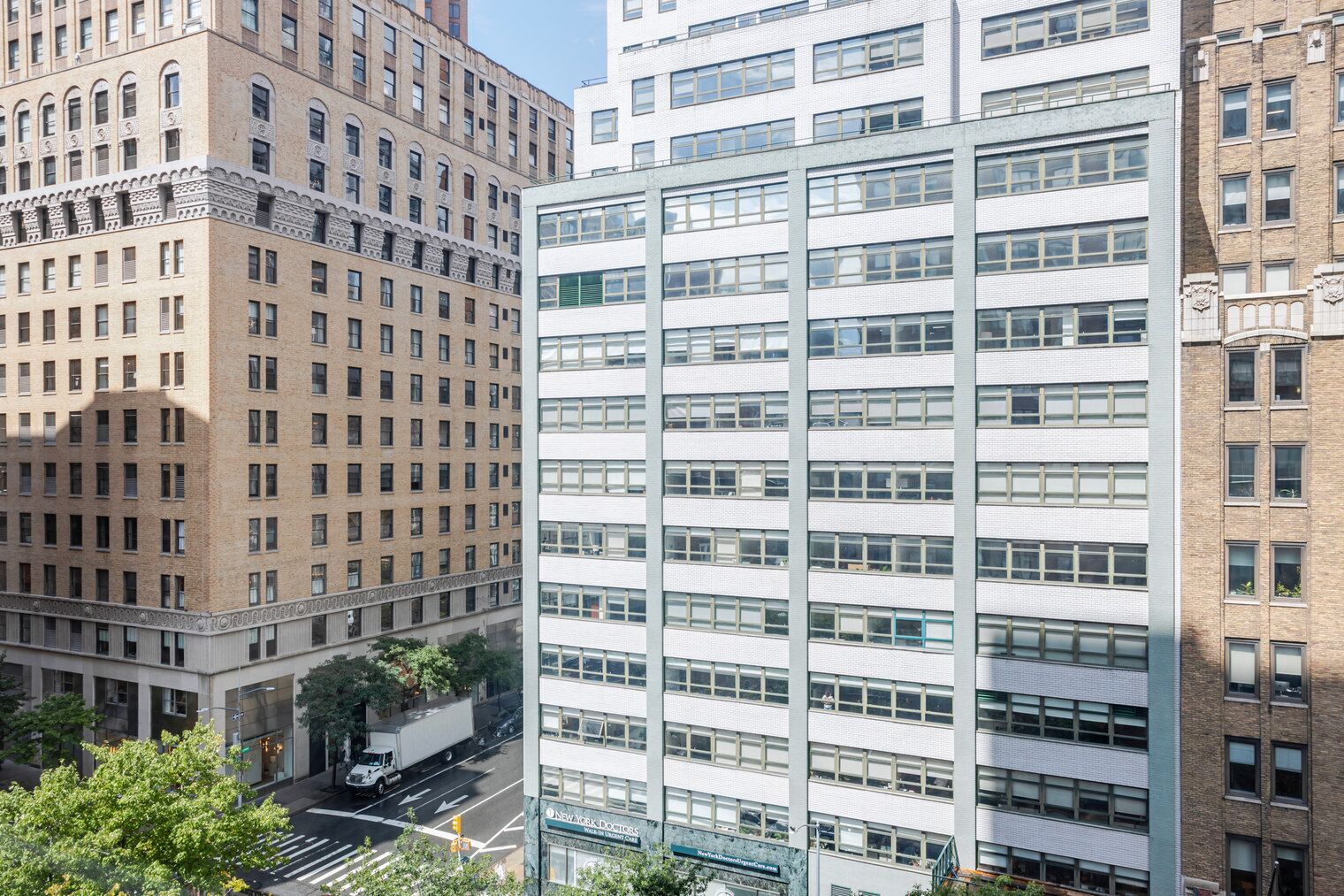 A multi-story building with a modern architectural style, featuring a mix of brick and glass facades.