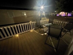 A wooden deck with a railing, a table, and chairs. - 8 Berth caravan Butlins Skegness (Skegness)