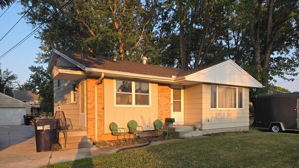 A single-story house with a front porch, a garage, and a small front yard. - Spacious 4-bedroom house in tranquil Farmington with yard and fire pit. (Farmington)