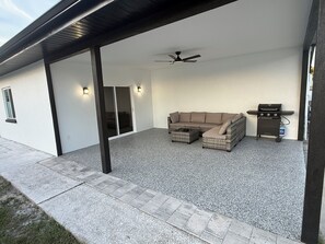 An outdoor patio with a sectional sofa, a ceiling fan, and a grill. - Perfect 3-Bedroom 2-Bathroom  completely remodeled and brand new furniture (Tampa)