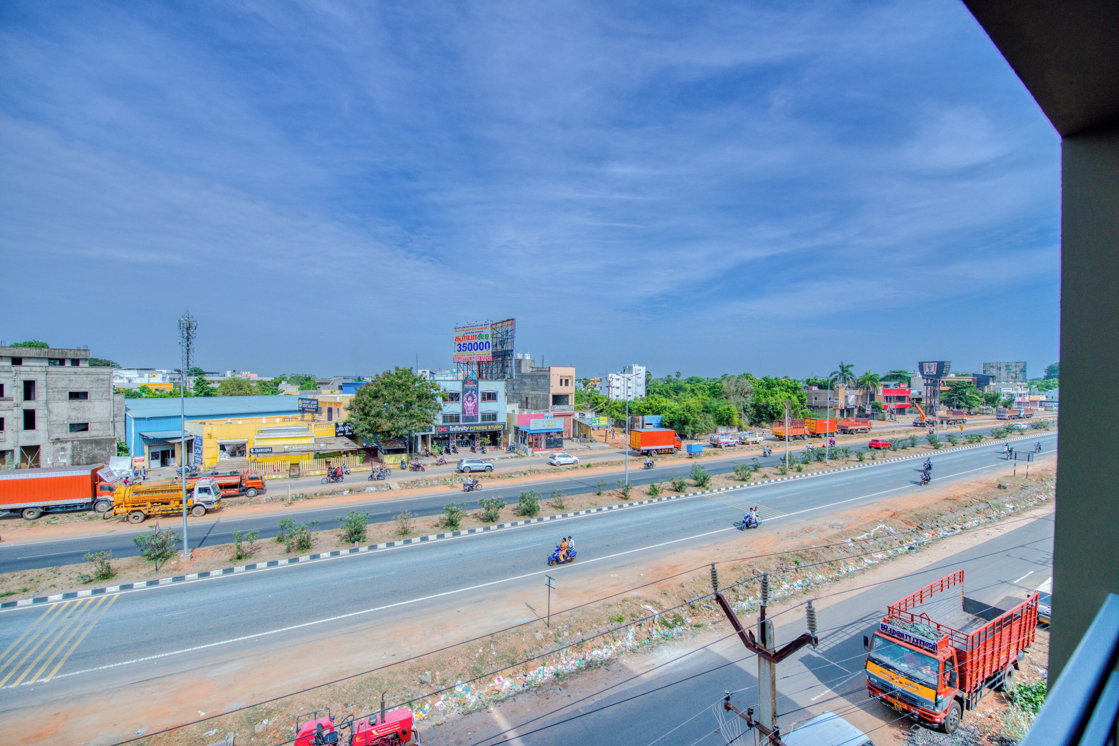 A multi-lane road with vehicles and a clear sky.