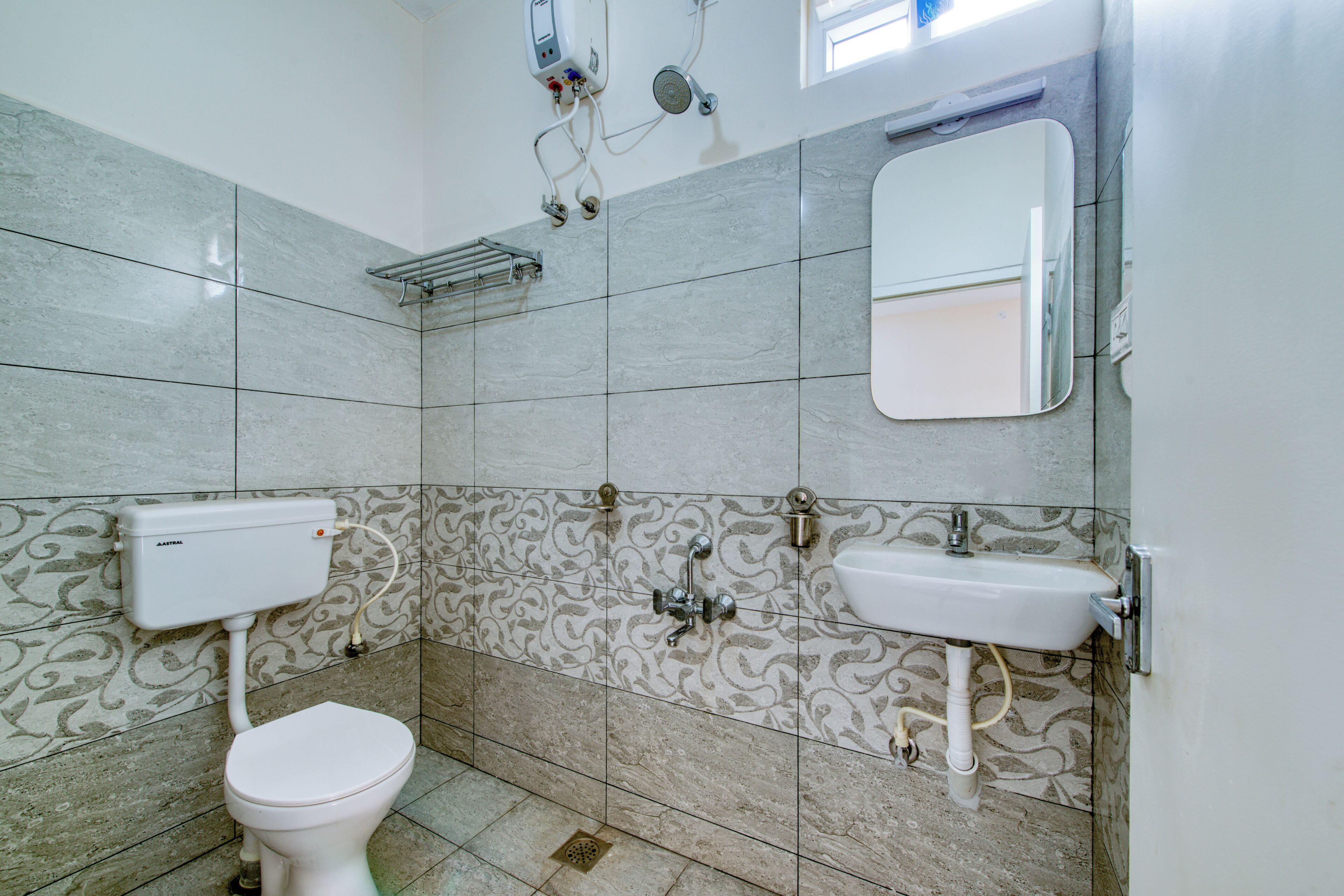 A bathroom with a toilet, a sink, and a shower.