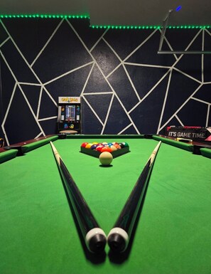 A pool table with a cue stick, a colorful ball rack, and a PACMAN arcade machine. - 5BR Disney Home, Private Pool, Spa & PS5 Game Loft (Davenport)